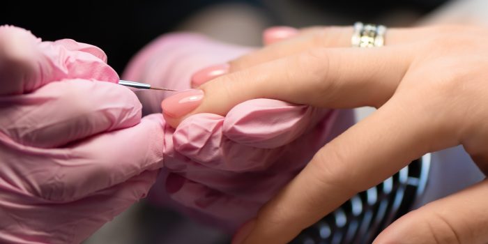Pink nail design. Female hand with glitter manicure